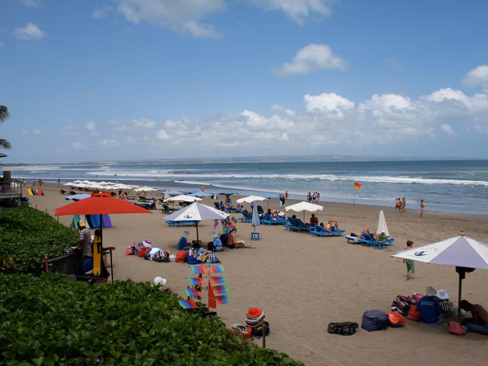 Praia de Seminyak, em Bali, com beach club e pôr do sol ao fundo