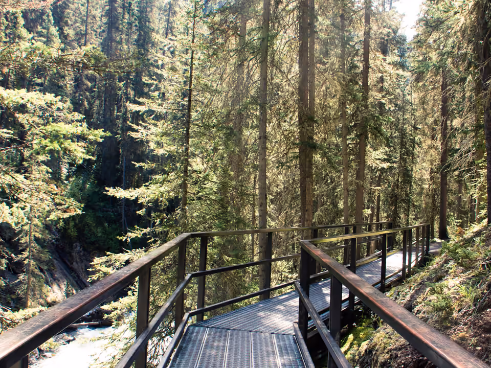 Passarela de metal suspensa dentro do desfiladeiro de Johnston Canyon, em Banff, ao lado da cachoeira