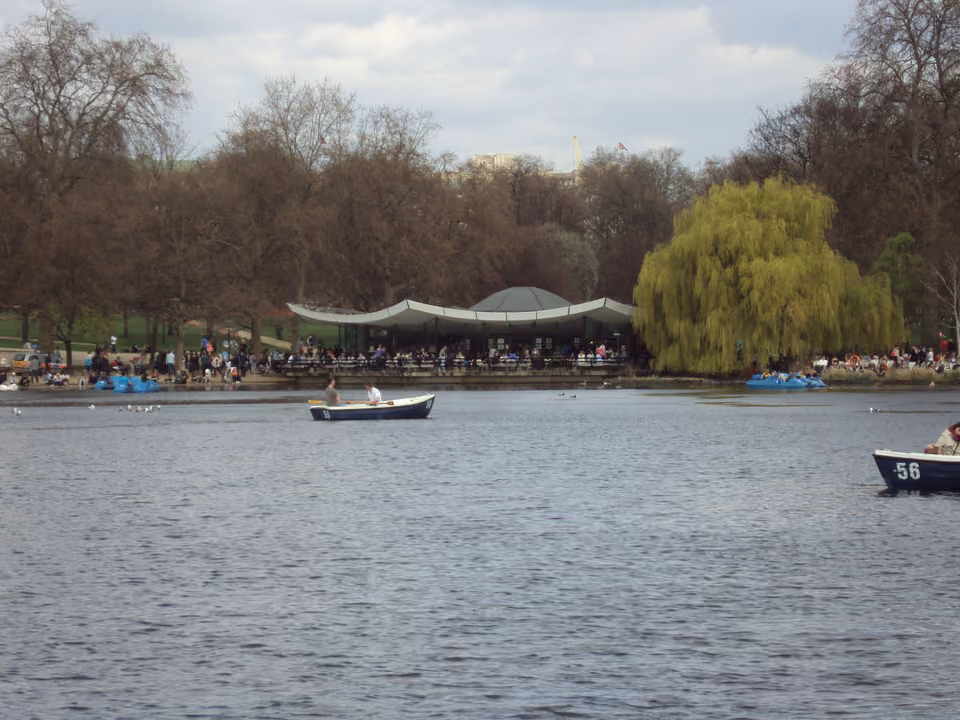 Área verde extensa do Hyde Park em Londres, com lago e árvores centenárias