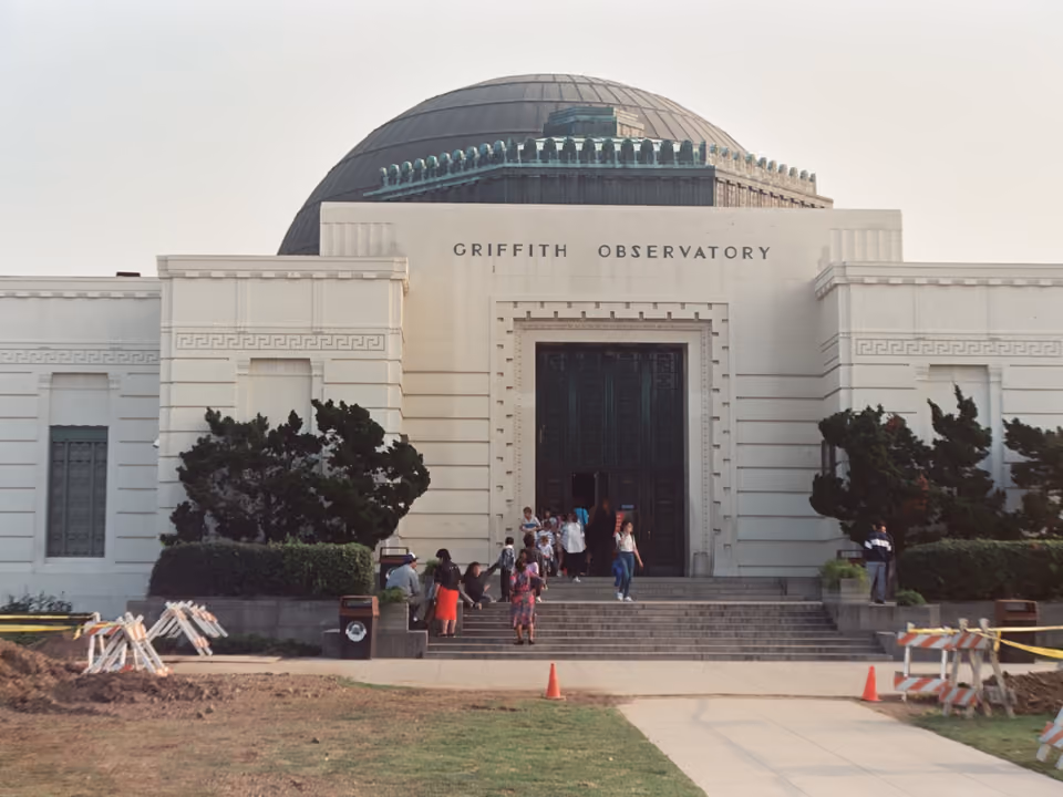 Griffith Observatory em Los Angeles, o prédio branco de cúpulas com vista para a cidade e o letreiro de Hollywood ao fundo