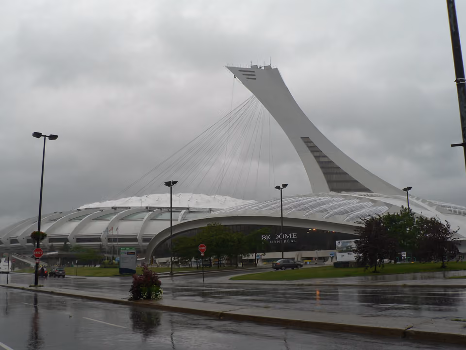 Fachada do Biodôme de Montreal à noite, dentro do antigo velódromo olímpico com a torre inclinada ao fundo