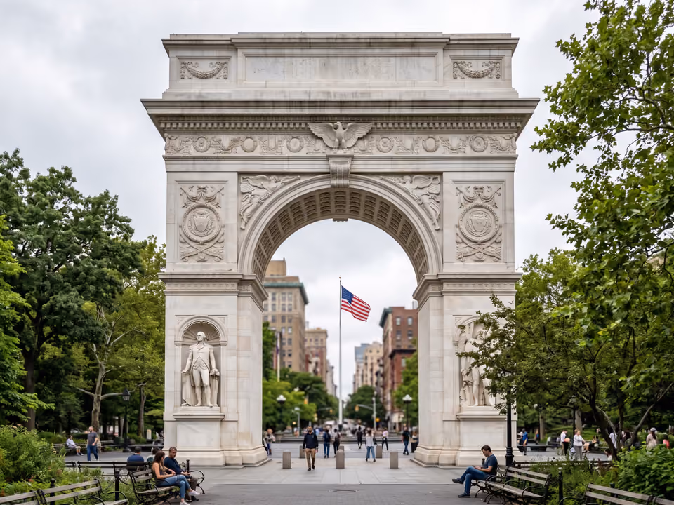 Arco de mármore do Washington Square Park, com a abóbada esculpida e árvores do parque ao redor