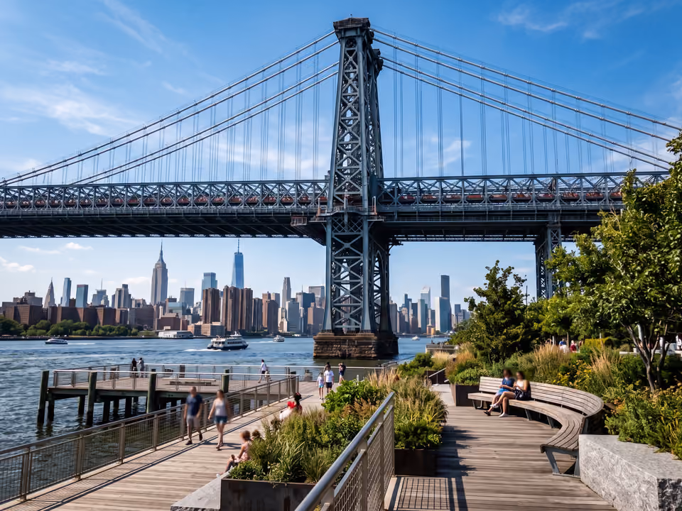 Vista do Domino Park em Williamsburg, com a torre da Williamsburg Bridge e o horizonte de Manhattan ao fundo